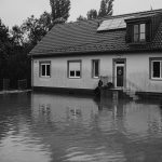 Flooded residential house with standing water outside during water damage emergency in Oakville