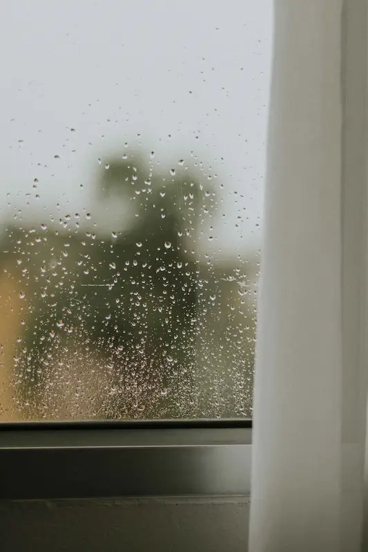 Signs of moisture buildup around a window in an Oakville home